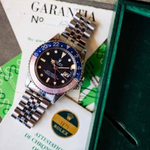 A great looking and very late production vintage Rolex 1675 GMT with original box and papers sold new in 1980. Featuring a beautiful original matte black Mark V dial with richly patina’d wheat color luminous tritium indexes and matching untouched tritium hour, minute, and 24 hour hands. With acrylic cyclops crystal, and nicely faded red and blue “Pepsi” bezel.