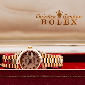 An especially fine and stunning example Rolex Lady President ref 69238 circa 1995 with factory set diamond lugs and pyramid dial. Featuring a 27mm 18K yellow gold case with fluted bezel and sapphire crystal. With beautiful condition silver “pyramid” textured dial with applied gold Roman figures and gold baton hands.